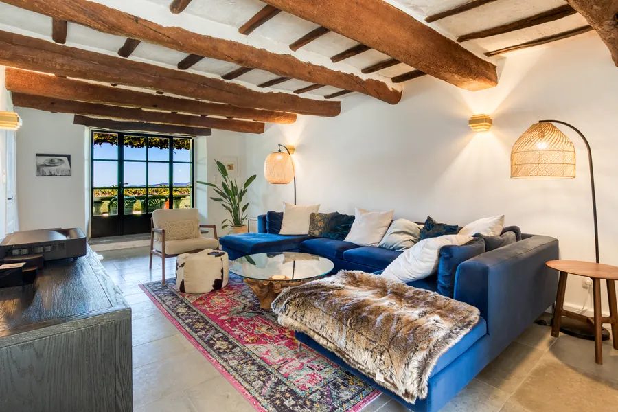 The den with exposed beams and vineyard views